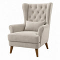 Beige oorfauteuil met hoge gecapitonneerde rugleuning en bruine houten poten, 82 x 90 x 110 cm